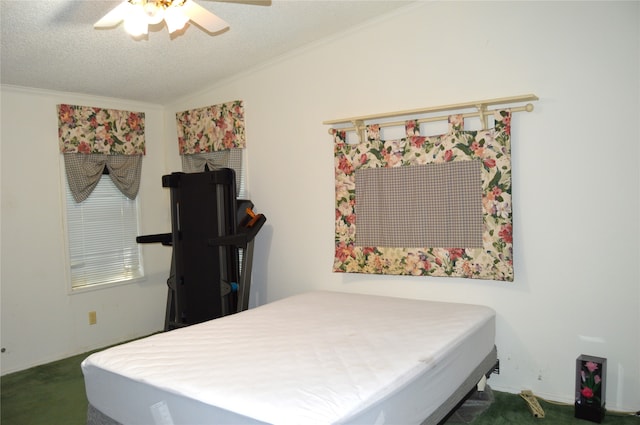 bedroom featuring a textured ceiling, ceiling fan, and carpet floors