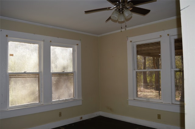 unfurnished room featuring ceiling fan, ornamental molding, and a wealth of natural light