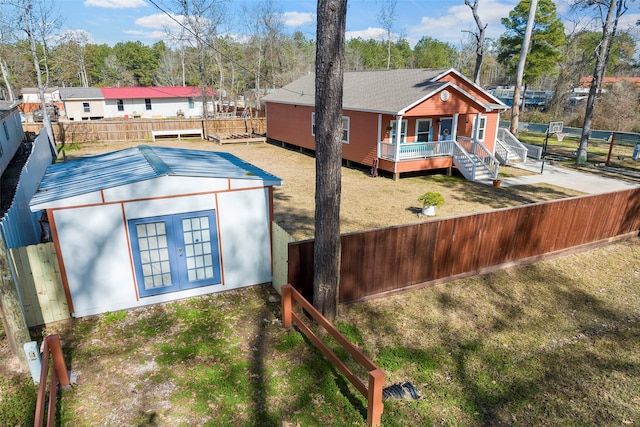 rear view of property with a deck and a lawn