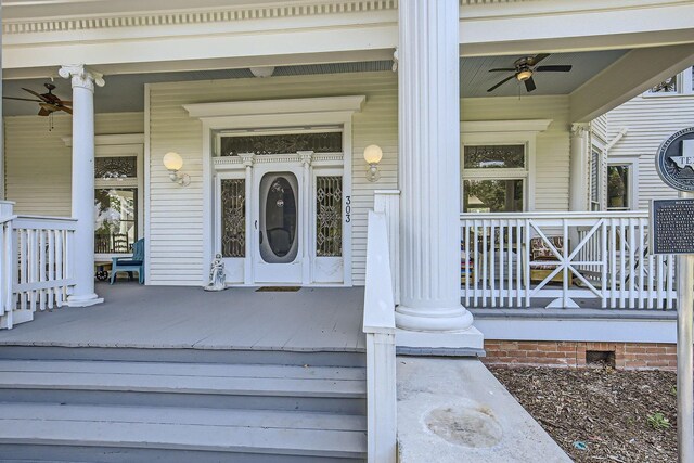 doorway to property featuring ceiling fan and a porch