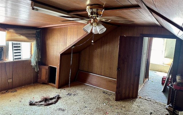 additional living space with wood walls, vaulted ceiling, ceiling fan, and wooden ceiling