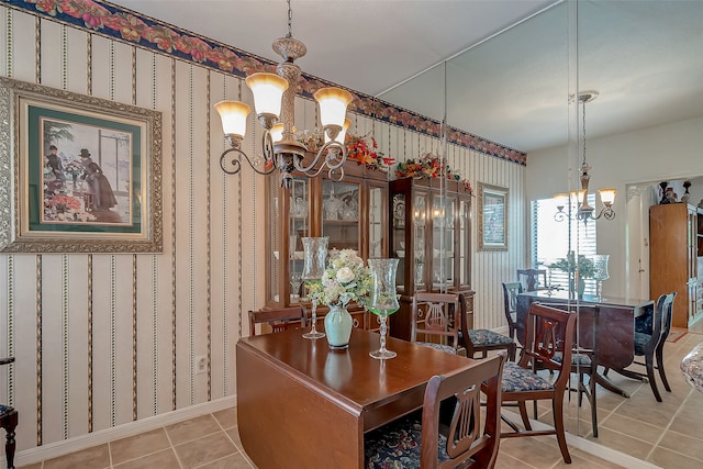 tiled dining space with an inviting chandelier