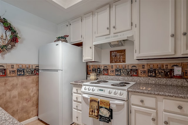 kitchen featuring white cabinets, light stone counters, and white appliances