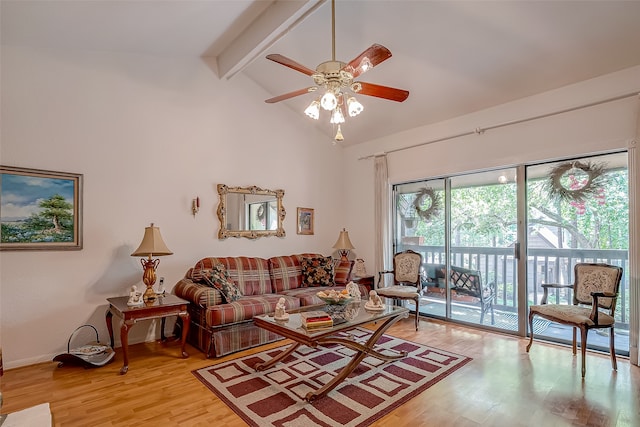 living room with ceiling fan, lofted ceiling with beams, and light wood-type flooring