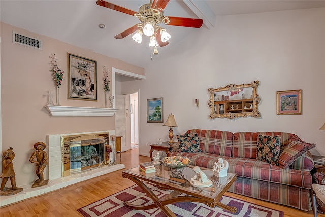 living room with vaulted ceiling with beams, hardwood / wood-style flooring, and ceiling fan