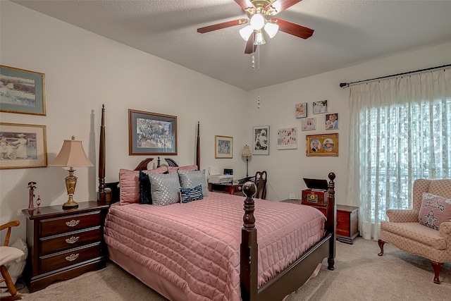 bedroom with ceiling fan, a textured ceiling, and light colored carpet