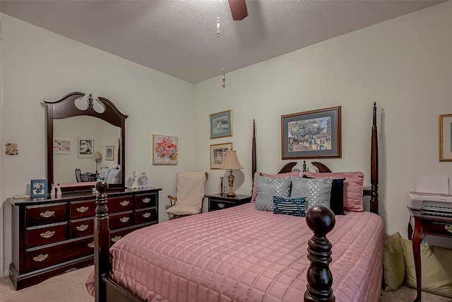 carpeted bedroom featuring a textured ceiling and ceiling fan