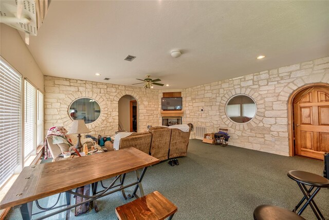 carpeted dining space with ceiling fan