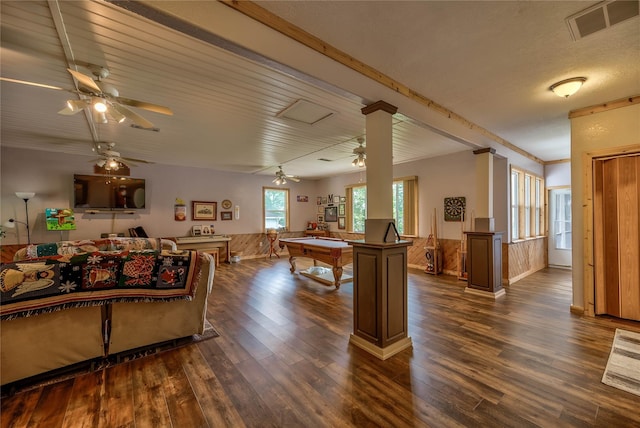 living room with decorative columns, crown molding, dark wood-type flooring, and pool table