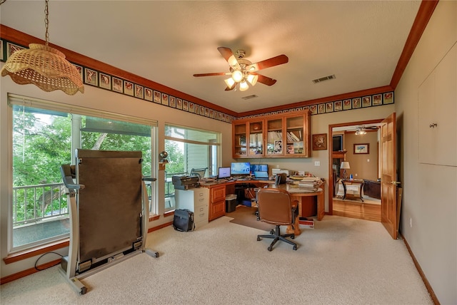 office area with ceiling fan, light colored carpet, plenty of natural light, and crown molding