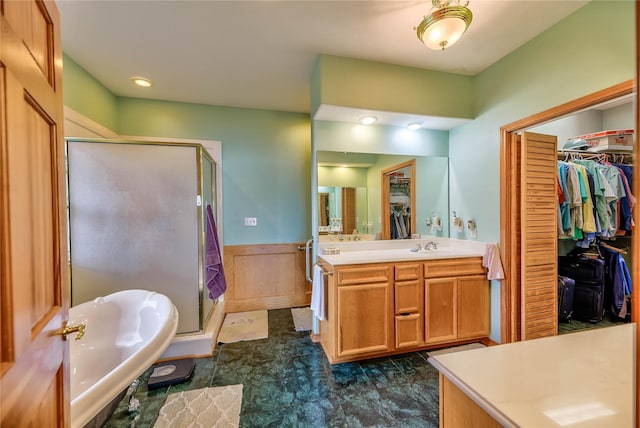 bathroom featuring vanity and independent shower and bath