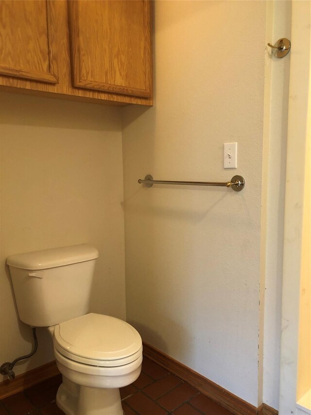 bathroom with tile patterned flooring and toilet