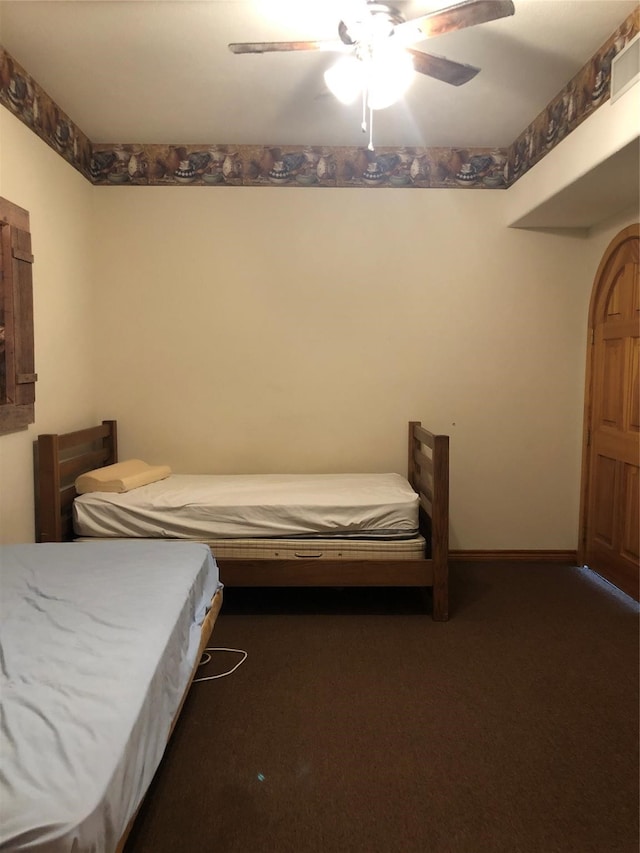 bedroom with dark carpet and ceiling fan