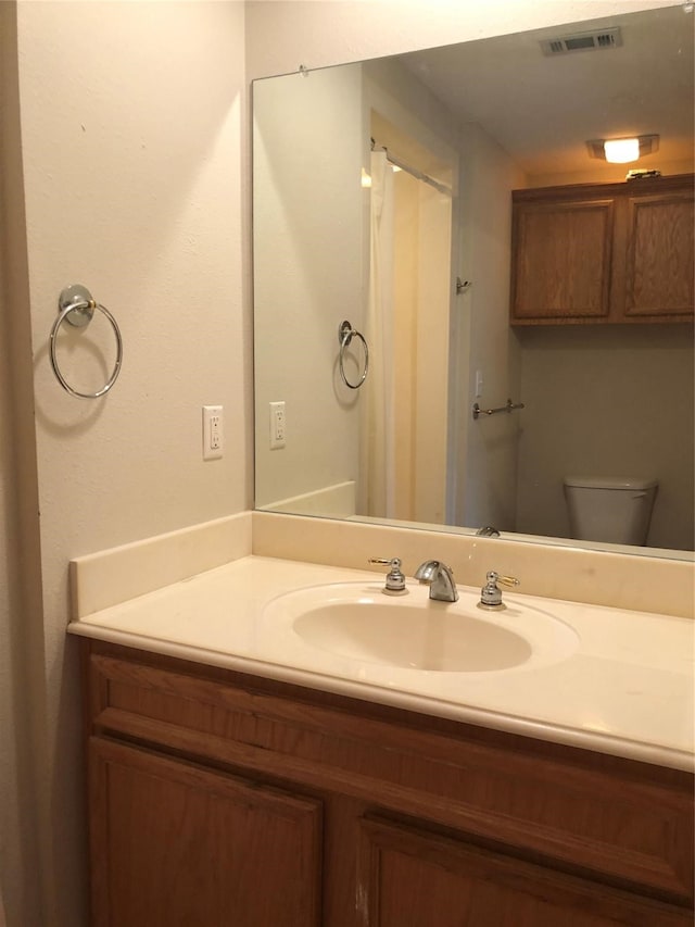 bathroom with vanity and toilet