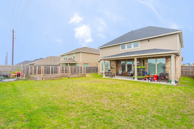 back of property featuring a lawn, a patio area, and a gazebo