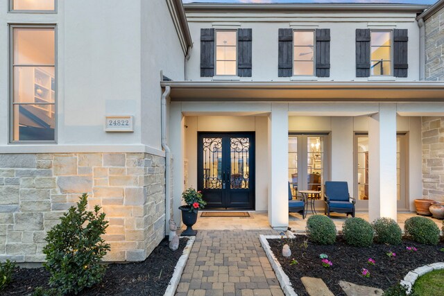 doorway to property featuring french doors and covered porch