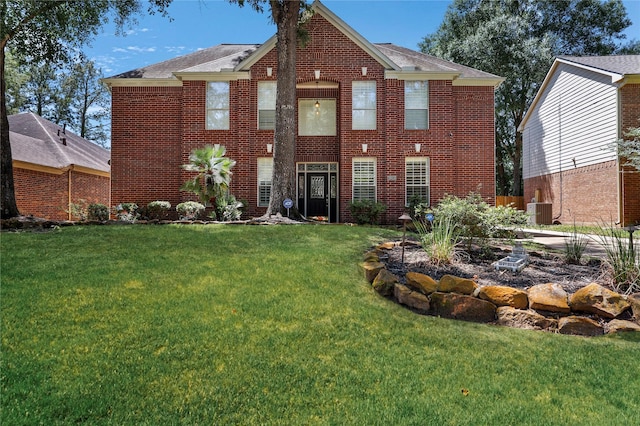 rear view of house featuring central AC, brick siding, and a lawn