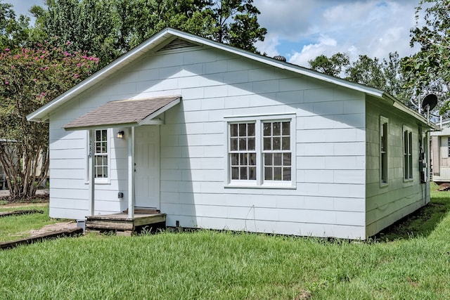 view of outdoor structure with a lawn