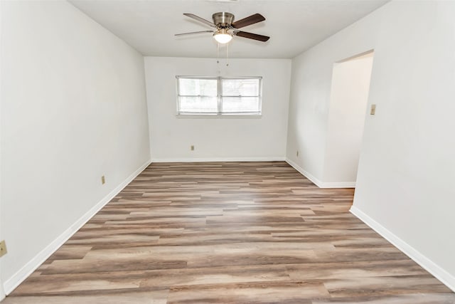 unfurnished room with ceiling fan and light wood-type flooring