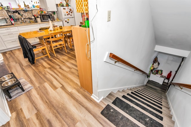 stairway with hardwood / wood-style floors