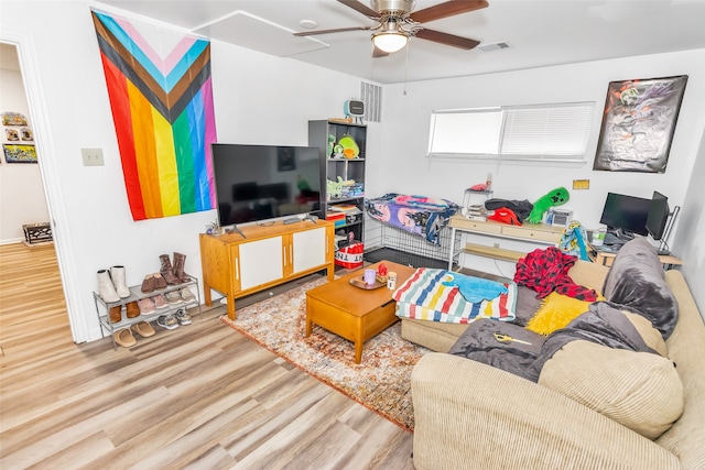 living room with ceiling fan and hardwood / wood-style flooring