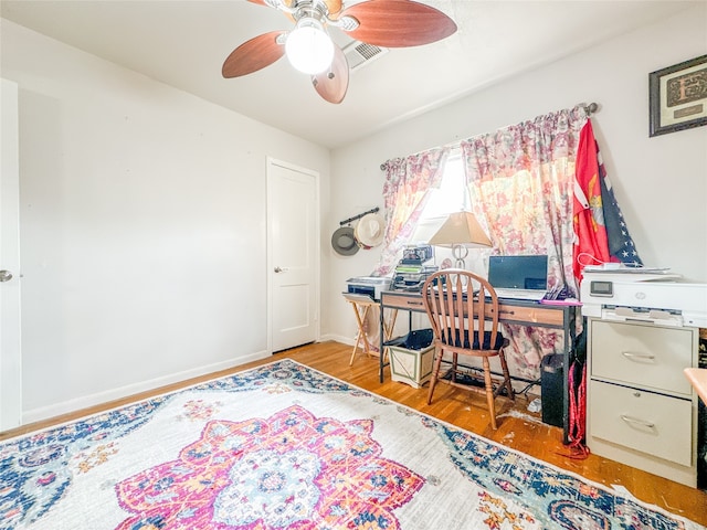 office area with light wood-type flooring and ceiling fan