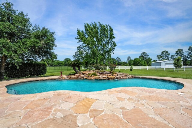 view of pool featuring a yard and a patio