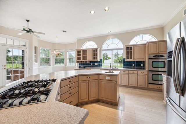 kitchen with sink, decorative backsplash, ornamental molding, light brown cabinetry, and stainless steel appliances