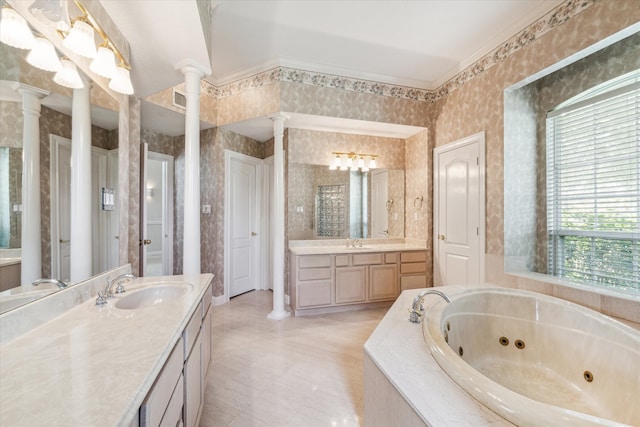 bathroom with vanity, tiled bath, ornate columns, and ornamental molding