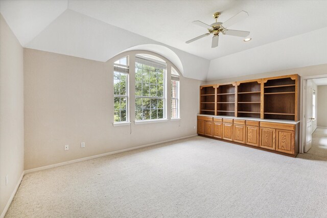 unfurnished living room with light carpet, ceiling fan, and lofted ceiling