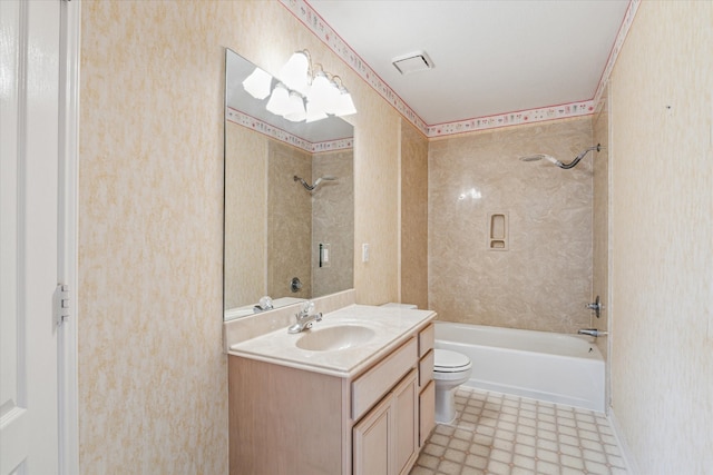 full bathroom featuring vanity, toilet, and tiled shower / bath