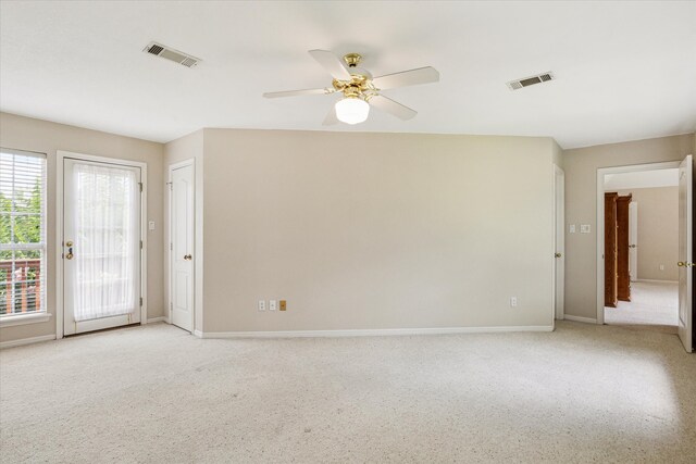 unfurnished room with light colored carpet and ceiling fan