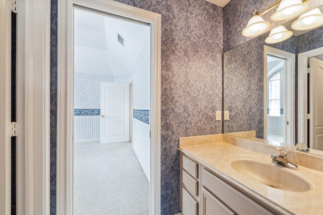 bathroom featuring vanity and a notable chandelier