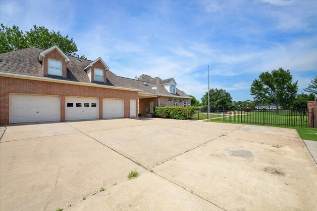 new england style home with a garage and a front yard