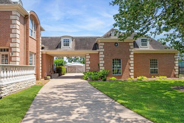 view of front of property with a front lawn and a carport