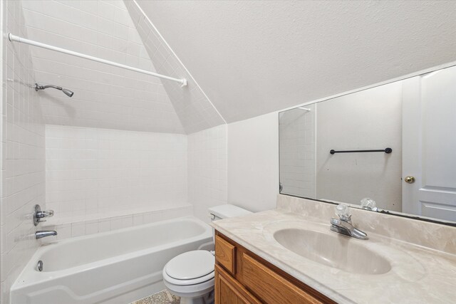 full bathroom featuring tiled shower / bath, vanity, and toilet