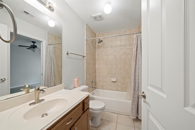 full bathroom with vanity, tile patterned flooring, ceiling fan, a textured ceiling, and toilet