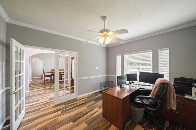 office area featuring wood-type flooring, french doors, a textured ceiling, ceiling fan, and crown molding