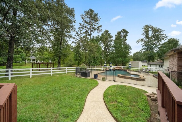 view of yard with a fenced in pool