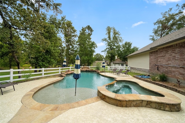 view of swimming pool featuring an in ground hot tub and a patio area