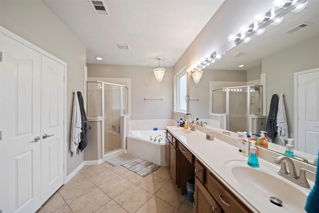 bathroom featuring tile patterned flooring, separate shower and tub, and vanity