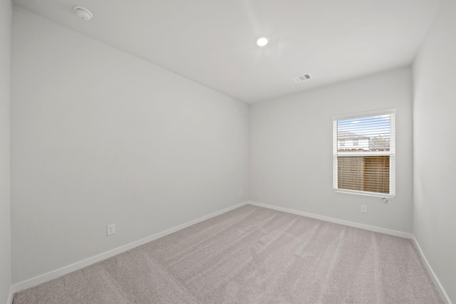 empty room with light colored carpet