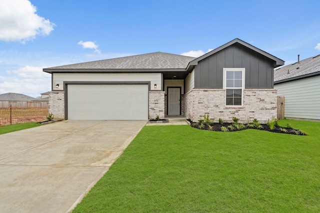 view of front of house featuring a front yard and a garage