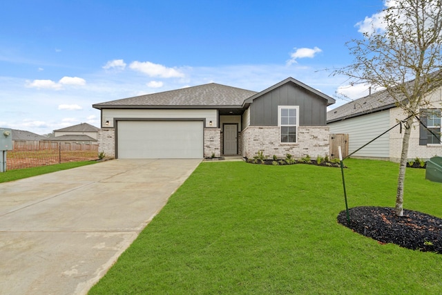 view of front of property with a front yard and a garage