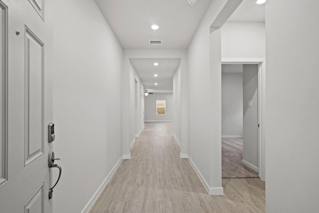 corridor with light hardwood / wood-style flooring