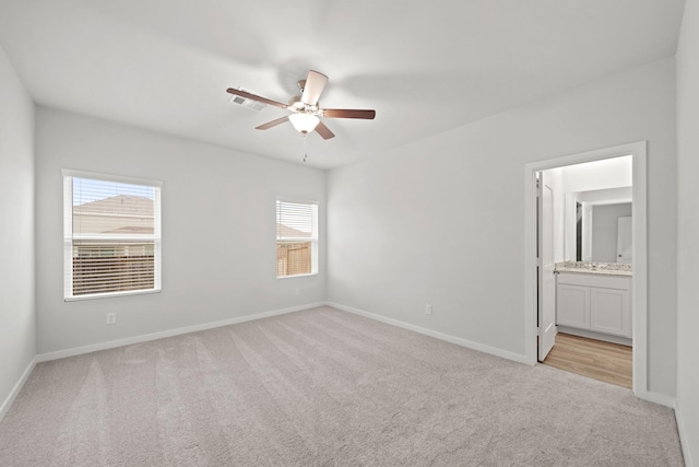 carpeted spare room with plenty of natural light and ceiling fan