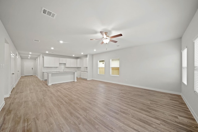 unfurnished living room with light hardwood / wood-style floors and ceiling fan