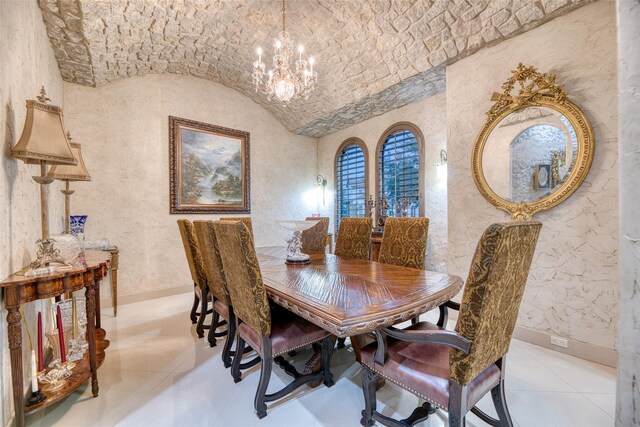 tiled dining area with an inviting chandelier and vaulted ceiling