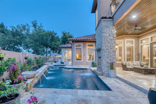 view of pool with ceiling fan, a patio, outdoor lounge area, and pool water feature