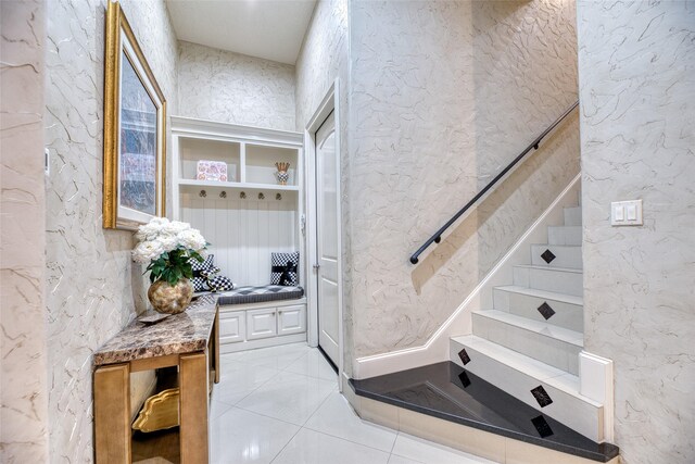 stairs featuring tile patterned flooring